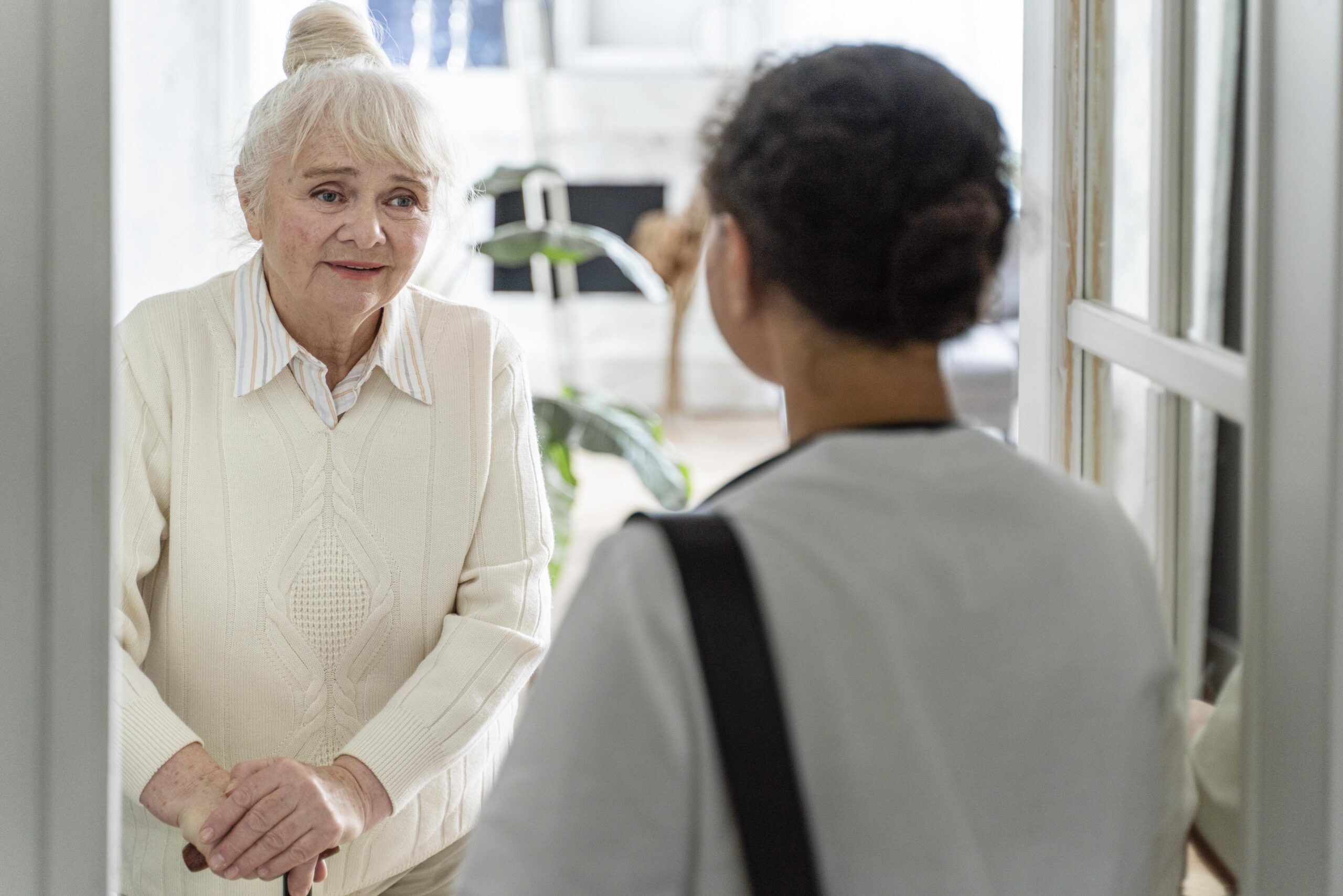 doctor-taking-care-senior-woman-home